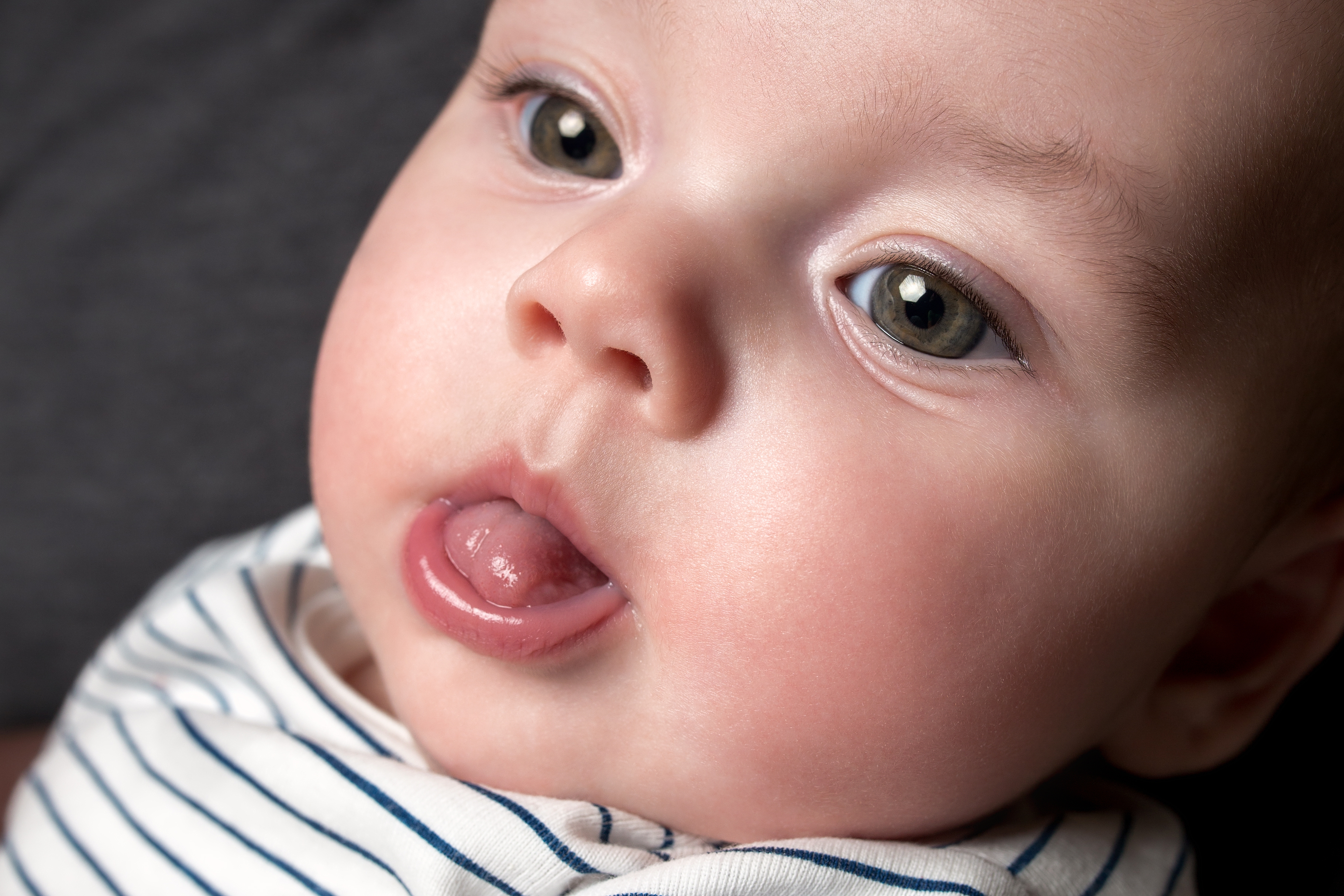 Малыш открывает рот. Ребенок с высунутым языком. Грудной ребёнок высовывает язык.